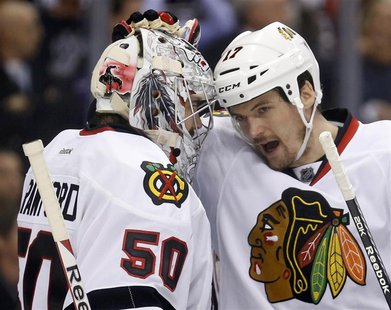 Chicago Blackhawks goalie Corey Crawford (50) gets a pat on the head from defenseman Sheldon Brookbank after their team defeated the Los Ang Chicago Blackhawks goalie Corey Crawford (50) gets a pat on the head from defenseman Sheldon Brookbank after their team defeated the Los Ang