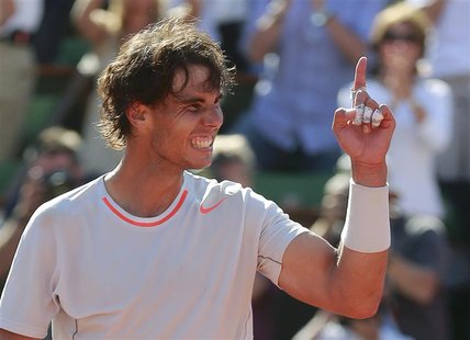 Rafael Nadal of Spain celebrates defeating Novak Djokovic of Serbia in their men's singles semi-final match during the French Open tennis to Rafael Nadal of Spain celebrates defeating Novak Djokovic of Serbia in their men's singles semi-final match during the French Open tennis to