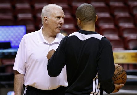 San Antonio Spurs Head Coach Gregg Popovich (L) speaks to guard Tony Parker during a team practice ahead of Game 2 of the NBA Finals basketb San Antonio Spurs Head Coach Gregg Popovich (L) speaks to guard Tony Parker during a team practice ahead of Game 2 of the NBA Finals basketb