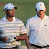Tiger Woods (L) of the U.S. walks off the driving range with his swing coach Hank Haney (R) before his practice round for the 2010 Masters g
