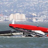 The Artemis Racing yacht is towed to shore after capsizing in the San Francisco Bay, California May 9, 2013. REUTERS/Jed Jacobsohn