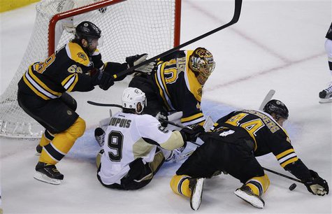 Boston Bruins' Jaromir Jagr (L) and Dennis Seidenberg (R) keep the puck away from Pittsburgh Penguins' Pascal Dupuis (9) and Boston Bruins g Boston Bruins' Jaromir Jagr (L) and Dennis Seidenberg (R) keep the puck away from Pittsburgh Penguins' Pascal Dupuis (9) and Boston Bruins g