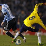 Lionel Messi (L) of Argentina tries to dribbles the ball under pressure from Aldo Ramirez of Colombia during their 2014 World Cup qualifying