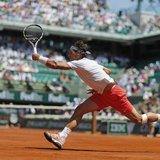 Rafael Nadal of Spain hits a return to Novak Djokovic of Serbia during their men's singles semi-final match at the French Open tennis tourna