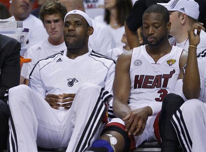 Miami Heat's LeBron James (L) and Dwyane Wade sit on the bench against the San Antonio Spurs during the third quarter in Game 1 of their NBA Miami Heat's LeBron James (L) and Dwyane Wade sit on the bench against the San Antonio Spurs during the third quarter in Game 1 of their NBA