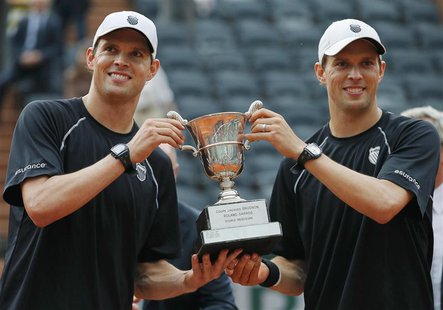 Bob Bryan and Mike Bryan of the U.S. pose with their trophy after defeating Michael Llodra and Nicolas Mahut of France in their men's double Bob Bryan and Mike Bryan of the U.S. pose with their trophy after defeating Michael Llodra and Nicolas Mahut of France in their men's double