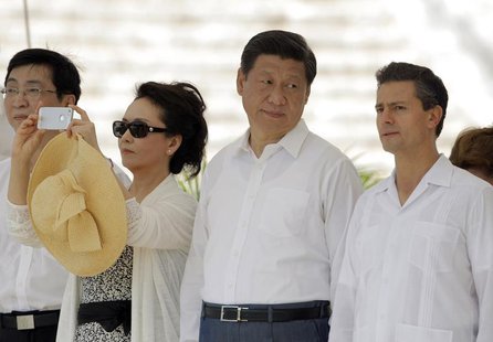 China's first lady Peng Liyuan (2nd L) takes a photograph as China's President Xi Jinping (2nd R) talks with his Mexican counterpart Enrique China's first lady Peng Liyuan (2nd L) takes a photograph as China's President Xi Jinping (2nd R) talks with his Mexican counterpart Enrique