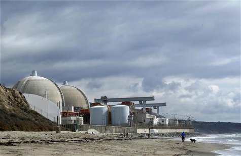 A man walks his dog next to the damaged San Onofre power plant located next to San Onofre State Park in California, in this November 8, 2012 A man walks his dog next to the damaged San Onofre power plant located next to San Onofre State Park in California, in this November 8, 2012