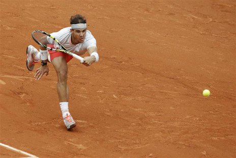 Rafael Nadal of Spain hits a return to compatriot David Ferrer during their men's singles final match at the French Open tennis tournament a Rafael Nadal of Spain hits a return to compatriot David Ferrer during their men's singles final match at the French Open tennis tournament a