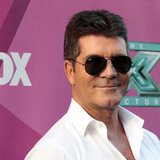 Judge Simon Cowell poses at the season two premiere of the television series "The X Factor" at Grauman's Chinese theatre in Hollywood, Calif Judge Simon Cowell poses at the season two premiere of the television series "The X Factor" at Grauman's Chinese theatre in Hollywood, Calif