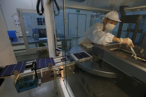 An employee works on a production line of solar panel at a factory of a photovoltaic company in Jiaxing, Zhejiang province June 5, 2013. REU An employee works on a production line of solar panel at a factory of a photovoltaic company in Jiaxing, Zhejiang province June 5, 2013. REU