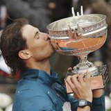 Rafael Nadal of Spain kisses the trophy after defeating compatriot David Ferrer in their men's singles final match to win the French Open te