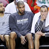 San Antonio Spurs' Tony Parker (L), Tim Duncan (C), and Manu Ginobili sit on the bench during their loss to the Miami Heat in Game 2 of thei