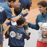 Rafael Nadal of Spain holds his trophy as he shakes hands with ball boys after defeating compatriot David Ferrer in their men's singles fina Rafael Nadal of Spain holds his trophy as he shakes hands with ball boys after defeating compatriot David Ferrer in their men's singles fina