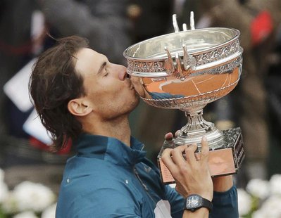 Rafael Nadal of Spain kisses the trophy after defeating compatriot David Ferrer in their men's singles final match to win the French Open te Rafael Nadal of Spain kisses the trophy after defeating compatriot David Ferrer in their men's singles final match to win the French Open te