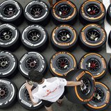 McLaren Formula One mechanic arranges Pirellis tyres in the paddock ahead of the Spanish Grand Prix at the Circuit de Catalunya in Montmelo,