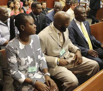 Tracy Martin and Sybrina Fulton (L), the parents of slain teen Trayvon Martin, with their attorney Benjamin Crump (R), watch the proceedings Tracy Martin and Sybrina Fulton (L), the parents of slain teen Trayvon Martin, with their attorney Benjamin Crump (R), watch the proceedings
