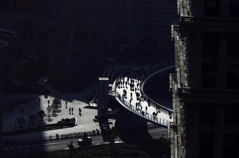 People walk at the financial district of Pudong in Shanghai January 17, 2012. REUTERS/Carlos Barria People walk at the financial district of Pudong in Shanghai January 17, 2012. REUTERS/Carlos Barria