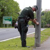 A Police Service of Northern Ireland officer seals a lampost along the road to the Lough Erne Golf Resort where the G8 summit will be held n