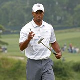 Tiger Woods of the U.S. bounces a ball on his putter as he leaves the 16th green during a practice round for the 2013 U.S. Open golf champio
