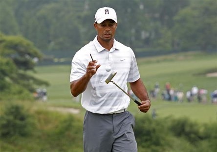Tiger Woods of the U.S. bounces a ball on his putter as he leaves the 16th green during a practice round for the 2013 U.S. Open golf champio Tiger Woods of the U.S. bounces a ball on his putter as he leaves the 16th green during a practice round for the 2013 U.S. Open golf champio