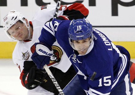 Toronto Maple Leafs' Matthew Lombardi (R) keeps the puck from Ottawa Senators' Sergei Gonchar during the third period of their NHL hockey ga Toronto Maple Leafs' Matthew Lombardi (R) keeps the puck from Ottawa Senators' Sergei Gonchar during the third period of their NHL hockey ga