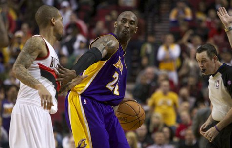 Los Angeles Lakers shooting guard Kobe Bryant (24) dribbles out the clock against the Portland Trail Blazers during second half of their NBA Los Angeles Lakers shooting guard Kobe Bryant (24) dribbles out the clock against the Portland Trail Blazers during second half of their NBA