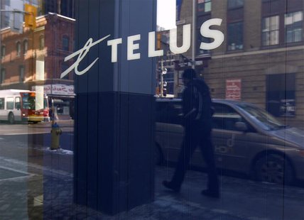 A pedestrian is reflected in the window of a Telus store while using a mobile phone in Ottawa February 11, 2011. REUTERS/Chris Wattie A pedestrian is reflected in the window of a Telus store while using a mobile phone in Ottawa February 11, 2011. REUTERS/Chris Wattie