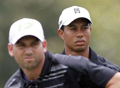 Tiger Woods watches Sergio Garcia tee off on the third hole during first round play in the WGC-Cadillac Championship golf tournament at the Tiger Woods watches Sergio Garcia tee off on the third hole during first round play in the WGC-Cadillac Championship golf tournament at the