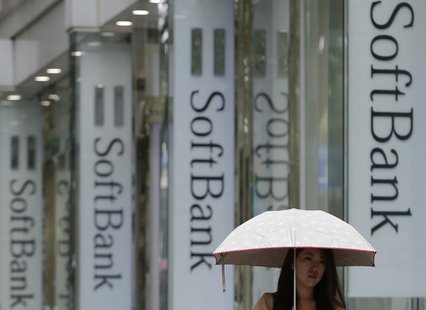 A woman walks past logos of SoftBank Corp at its branch in Tokyo June 11, 2013. REUTERS/Yuya Shino A woman walks past logos of SoftBank Corp at its branch in Tokyo June 11, 2013. REUTERS/Yuya Shino