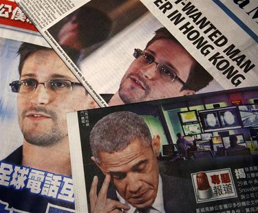 Photos of Edward Snowden, a contractor at the National Security Agency (NSA), and U.S. President Barack Obama are printed on the front pages Photos of Edward Snowden, a contractor at the National Security Agency (NSA), and U.S. President Barack Obama are printed on the front pages