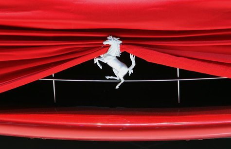 A cover is pictured on a Ferrari car at Ferrari booth during a preview day of the upcoming 80th Geneva Car Show at the Palexpo in Geneva Mar A cover is pictured on a Ferrari car at Ferrari booth during a preview day of the upcoming 80th Geneva Car Show at the Palexpo in Geneva Mar