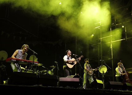 English folk rock band Mumford and Sons' Marcus Mumford (2nd L), Winston Marshall (2nd R), Ted Dwane (R) and Ben Lovett (L) perform on the m English folk rock band Mumford and Sons' Marcus Mumford (2nd L), Winston Marshall (2nd R), Ted Dwane (R) and Ben Lovett (L) perform on the m