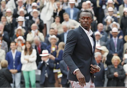 Jamaican sprinter Usain Bolt walks to present trophies during the victory ceremony following the men's singles final match between Rafael Na Jamaican sprinter Usain Bolt walks to present trophies during the victory ceremony following the men's singles final match between Rafael Na