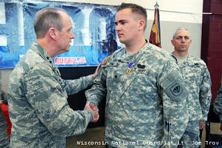 Maj. Gen. Donald Dunbar, the adjutant general of Wisconsin, awards the Purple Heart to Spc. Chase Crull, of Hollandale, Wis. (courtesy of WI National Guard). Maj. Gen. Donald Dunbar, the adjutant general of Wisconsin, awards the Purple Heart to Spc. Chase Crull, of Hollandale, Wis. (courtesy of WI National Guard).