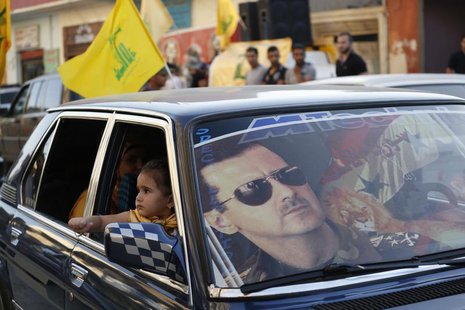 An image of Syria's President Bashar al-Assad is seen on a car's windscreen as Hezbollah supporters celebrate, after the Syrian army took co An image of Syria's President Bashar al-Assad is seen on a car's windscreen as Hezbollah supporters celebrate, after the Syrian army took co