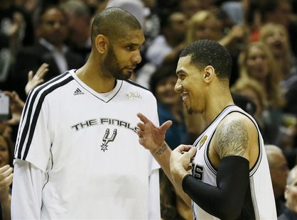 San Antonio Spurs' Danny Green (R) is congratulated by teammate Tim Duncan as he comes out of the game against the Miami Heat during the sec San Antonio Spurs' Danny Green (R) is congratulated by teammate Tim Duncan as he comes out of the game against the Miami Heat during the sec