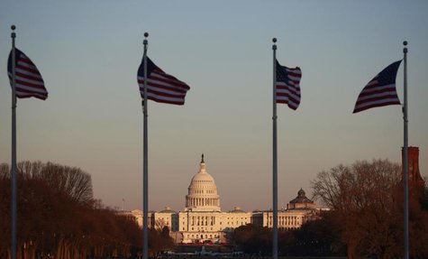 Flags at the Washington Monument flutter in the breeze as the sun casts its last rays on the U.S. Capitol Building in Washington February 5, Flags at the Washington Monument flutter in the breeze as the sun casts its last rays on the U.S. Capitol Building in Washington February 5,