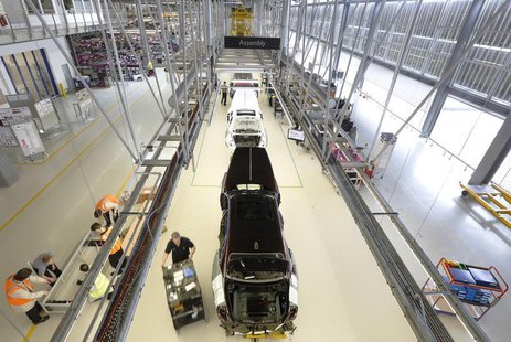 Employees work on the production line for the Rolls Royce Ghost at the Rolls Royce Motor Cars factory at Goodwood near Chichester in souther Employees work on the production line for the Rolls Royce Ghost at the Rolls Royce Motor Cars factory at Goodwood near Chichester in souther