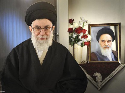 Iran's Supreme Leader Ayatollah Ali Khamenei sits next to a portrait of late leader Ayatollah Ruhollah Khomeini while taking part in a telev Iran's Supreme Leader Ayatollah Ali Khamenei sits next to a portrait of late leader Ayatollah Ruhollah Khomeini while taking part in a telev