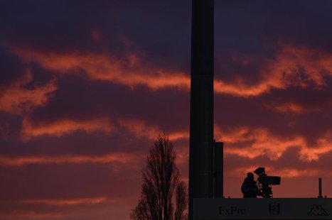 An ESPN cameraman is seen against an evening sky while filming Fulham and Manchester United warm up before their English Premier League socc An ESPN cameraman is seen against an evening sky while filming Fulham and Manchester United warm up before their English Premier League socc