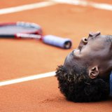 France's Gael Monfils lies on the court during his semi-final match against Switzerland's Roger Federer at the French Open tennis tournament France's Gael Monfils lies on the court during his semi-final match against Switzerland's Roger Federer at the French Open tennis tournament