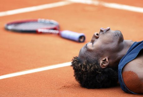 France's Gael Monfils lies on the court during his semi-final match against Switzerland's Roger Federer at the French Open tennis tournament France's Gael Monfils lies on the court during his semi-final match against Switzerland's Roger Federer at the French Open tennis tournament