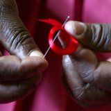 A Kenyan woman prepares ribbons ahead of World Aids Day at Beacon of Hope centre, a non-government organization formed to address women's pr A Kenyan woman prepares ribbons ahead of World Aids Day at Beacon of Hope centre, a non-government organization formed to address women's pr