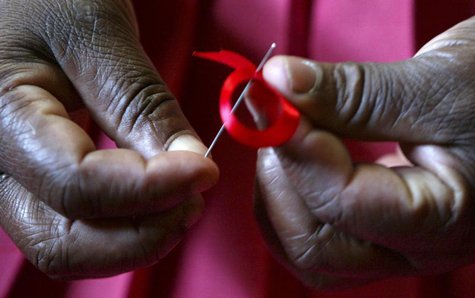A Kenyan woman prepares ribbons ahead of World Aids Day at Beacon of Hope centre, a non-government organization formed to address women's pr A Kenyan woman prepares ribbons ahead of World Aids Day at Beacon of Hope centre, a non-government organization formed to address women's pr