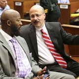 Assistant State Attorney Bernie de la Rionda (R) talks to Tracy Martin, the father of Trayvon Martin, at the George Zimmerman trial in Semin
