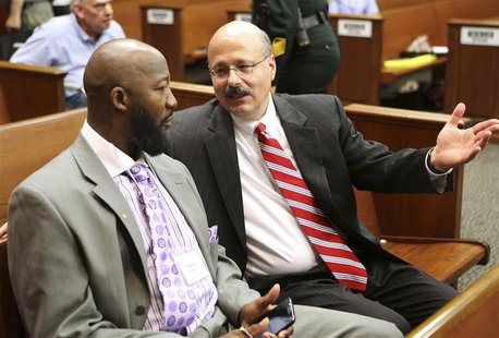 Assistant State Attorney Bernie de la Rionda (R) talks to Tracy Martin, the father of Trayvon Martin, at the George Zimmerman trial in Semin Assistant State Attorney Bernie de la Rionda (R) talks to Tracy Martin, the father of Trayvon Martin, at the George Zimmerman trial in Semin