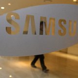 A man walks behind a logo of Samsung Electronics at the company's headquarters in Seoul April 30, 2010. REUTERS/Jo Yong-Hak A man walks behind a logo of Samsung Electronics at the company's headquarters in Seoul April 30, 2010. REUTERS/Jo Yong-Hak