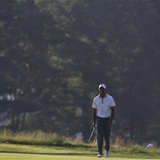 Tiger Woods of the U.S. walks on the 14th fairway during a practice round for the 2013 U.S. Open golf championship at the Merion Golf Club i