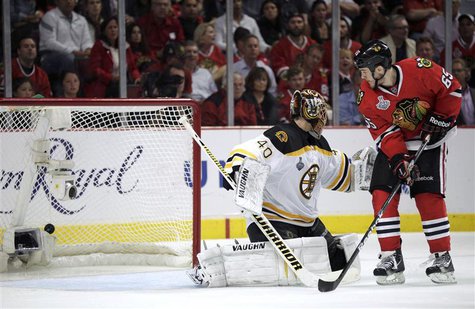 Chicago Blackhawks' Andrew Shaw (65) scores the game-winning goal past Boston Bruins goalie Tuukka Rask during triple overtime in Game 1 of Chicago Blackhawks' Andrew Shaw (65) scores the game-winning goal past Boston Bruins goalie Tuukka Rask during triple overtime in Game 1 of